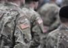 Soldiers in camouflage uniforms with U.S. flag patches