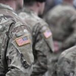 Soldiers in camouflage uniforms with U.S. flag patches