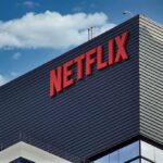 Netflix Purge Signals Bigger Power Struggle Netflix logo on modern office building exterior