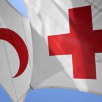 Athens Horror Triggers Red Cross Takedown Red Cross and Red Crescent flags against blue sky