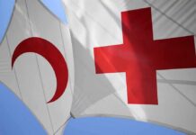 Athens Horror Triggers Red Cross Takedown Red Cross and Red Crescent flags against blue sky