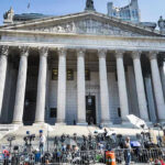 NYPD Critic Suddenly Runs Enforcement Reporters and photographers gathered outside a neoclassical courthouse