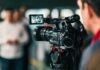 On-Camera Twist: Two-Day Hunt Ends Mid-Press Video camera filming a group of people