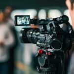 On-Camera Twist: Two-Day Hunt Ends Mid-Press Video camera filming a group of people