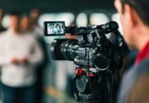 On-Camera Twist: Two-Day Hunt Ends Mid-Press Video camera filming a group of people
