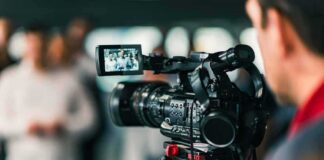 Video camera filming a group of people