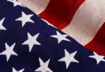 TV Icon Torches America-Bashers – Door’s That Way American flag close-up with stars and stripes