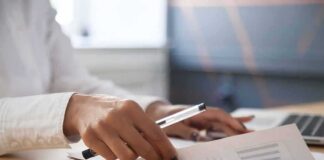 Hands reviewing documents at a desk