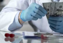 Gloved hands in a lab coat counting US dollar bills
