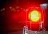 Flash Flood Hurls Jeep – Mountain Storm Turns Deadly Fast Red emergency warning light with protective cage glowing at night