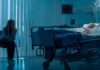 Beloved Headliner Down – MGM Responds hospital room with child in bed and adult sitting nearby