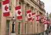 New Euro-Canada Club Threatens U.S. Deals Canadian flags on a neoclassical building facade