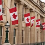 New Euro-Canada Club Threatens U.S. Deals Canadian flags on a neoclassical building facade