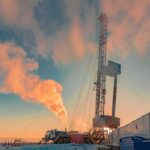 China Oil Crash? Sinopec Sounds Alarm Oil drilling rig at sunset releasing steam