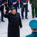 Man in black coat tipping hat during formal ceremony