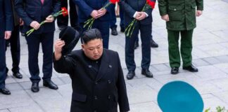 Man in black coat tipping hat during formal ceremony