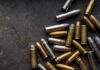 Shipping Meltdown: Bullets Land in Art Class Assorted handgun cartridges on a dark metal surface