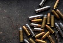 Shipping Meltdown: Bullets Land in Art Class Assorted handgun cartridges on a dark metal surface