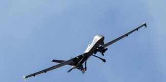 military drone flying in a clear blue sky