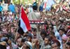 All-In Call Rocks Yemen – Amnesty Dangles For Defectors Crowd at a protest rally; Katherine Hull-Kirk, Farveez Maharoof, Bimal Lakra, Isha Lakhani, and Colin David Jones present