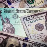United States Treasury check on top of US dollar bills