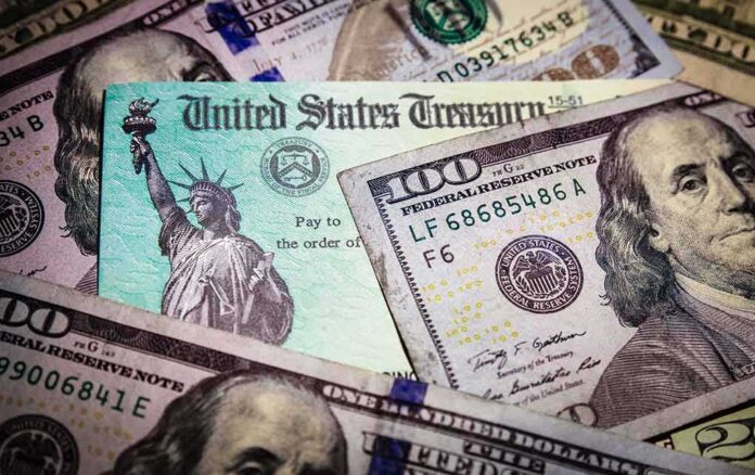 shutterstock_1691728840 United States Treasury check on top of US dollar bills