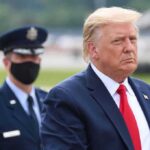 Trump’s SHOCKING Meeting in Secret Chinese Compound Donald Trump walking outdoors with an officer behind him; Chuck Howley not visible