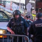 Drones, Barricades—Violence Slips Through Police officers in tactical gear near a patrol vehicle at night