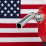 CNN Warns: Pump Pain Dooms Majorities gas pump nozzle with droplet against American flag background