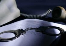 Phone Records Grabbed – Who Got Swept? Handcuffs on a document beside a coiled telephone handset