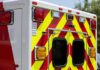Qualified EMT Axed Over Homeschool Label Rear of an ambulance with chevron stripes and lights