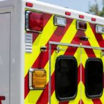 Qualified EMT Axed Over Homeschool Label Rear of an ambulance with chevron stripes and lights