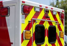 Qualified EMT Axed Over Homeschool Label Rear of an ambulance with chevron stripes and lights