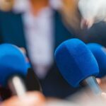 Microphones clustered at a press event