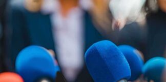 Microphones clustered at a press event