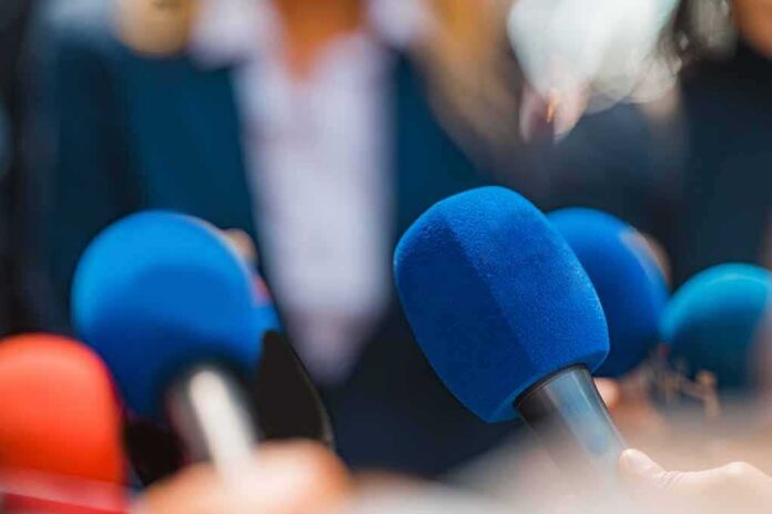 Microphones clustered at a press event