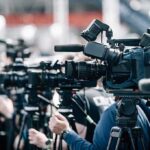 Dallas Shockwave: Paxton Plots Power Play Broadcast cameras on tripods at a press event