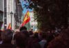 Stretcher Eviction Sparks Nationwide Fury Crowd with Spanish flags in a city street