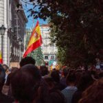 Stretcher Eviction Sparks Nationwide Fury Crowd with Spanish flags in a city street
