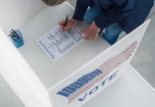 Voter filling out a ballot in a private voting booth