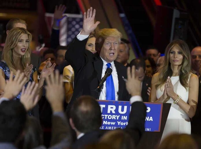 shutterstock_415321102 Donald Trump speaks at a rally with Ivanka Trump and Melania Trump on stage; Karlie Kloss in the crowd