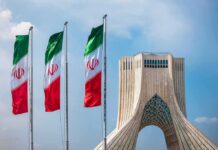Currency Freefall – Rial Meltdown Sparks Furious Streets Iranian flags beside Azadi Tower in Tehran