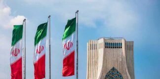 Iranian flags beside Azadi Tower in Tehran