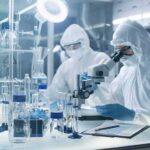 New DNA Timeline Rocks Plague History Scientists in protective suits using a microscope in a laboratory