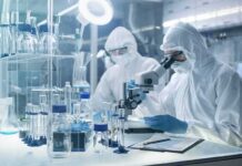New DNA Timeline Rocks Plague History Scientists in protective suits using a microscope in a laboratory
