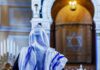 Synagogue Shock: Teen Slashed Mid-Prayer Person in white and blue prayer shawl facing ornate interior