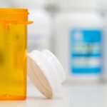 Long-Term Prilosec? Doctors Hit Brakes Empty orange prescription bottle with white cap
