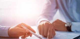 Hands reviewing a document with a pen