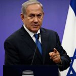 Bank of Israel Torpedoes Crypto Workaround man in suit speaking at a podium with an Israeli flag