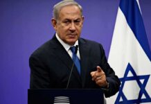 Bank of Israel Torpedoes Crypto Workaround man in suit speaking at a podium with an Israeli flag
